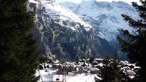 Small Bernese Highland snowy Switzerland village among mountain range