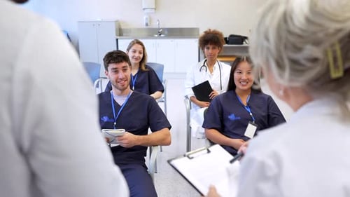 Medical Students Listening to Senior Doctor During Hospital Training