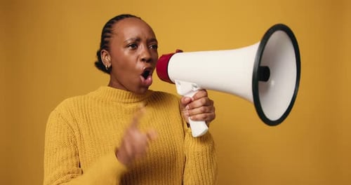 Megaphone, shouting and black woman in studio for protest, democracy or human rights activism