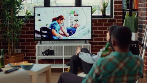 Friends Relaxing Indoors Watching TV Together