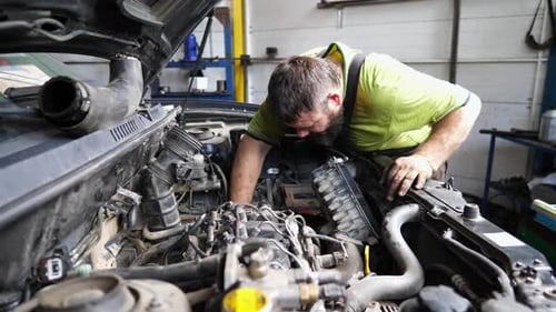 Professional Repairman Inspecting Car Engine at Service Adult Auto Mechanic Working Under Hood of