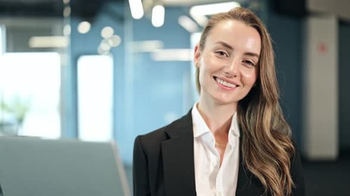 Confident Businesswoman Smiling In Modern Office