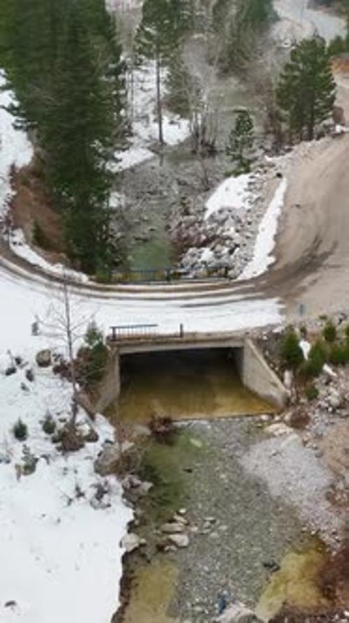 Vertical Video Cinematic Winter Magic Aerial View of Mountains River and Breathtaking Waterfalls