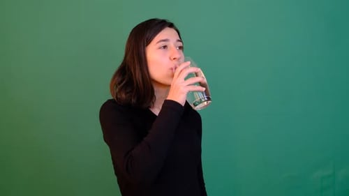 Young Woman Drinking Water on Green Screen