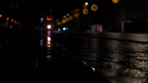 Wet Pavement Reflecting City Lights at Night