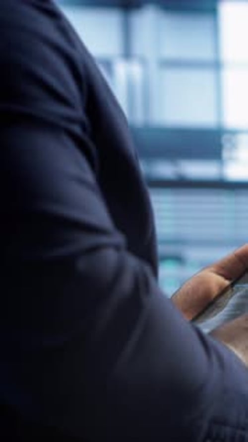 Man in Suit Using Smartphone in Office