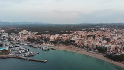 Aerial footage of empty beach and the city on island