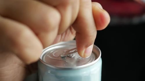 Opening a Refreshing Soda Can in Close Up