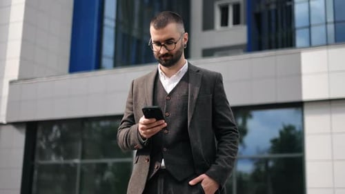Fashion Modern Business Man in Suit Smiling Thinking Use Smartphone Outdoor Downtown Office