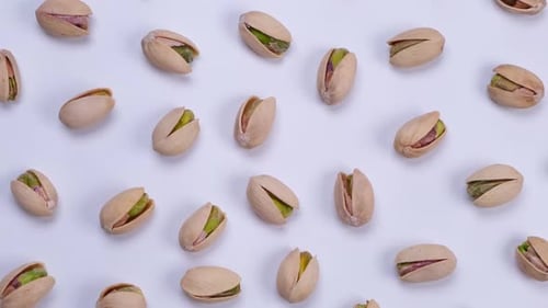 Pile of Pistachios in Shells on White