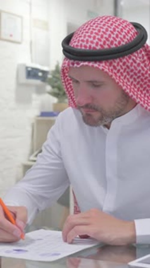 Middle Aged Muslim Man Working on Documents in Office, vertical video