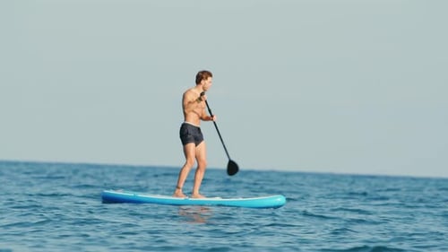 Man On A Stand Up Paddle in the Sea