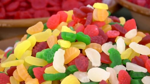 Colorful sweets candies for sale on the market. A pile of jelly candies on the market. Delicious mul