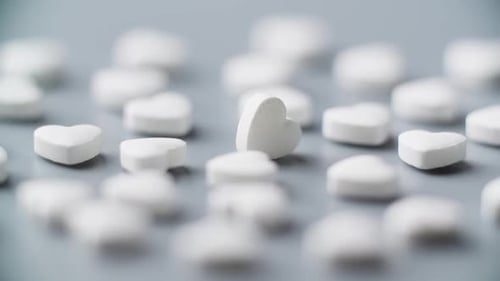 Pills Rotating on Table Heart Shape Healthcare Concept Drug Medicament