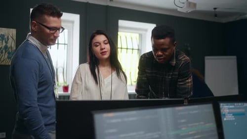 Teamwork in IT Company Caucasian Black and Indian Persons Discussing Project Looking at Display