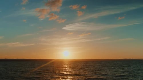 Golden Sunset Over the Ocean with Rippling Water