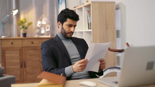 Handsome Businessman in Stylish Suit Carefully Checking the Papers Finds What He Was Looking for