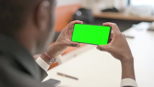 Holding Horizontal Smartphone with Green Screen