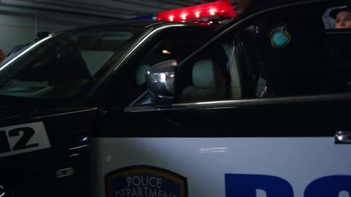 Police Officers Exiting Car with Guns Drawn in Garage