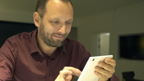 Man Uses Tablet Indoors