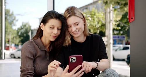 Young Women Using Smartphone on Street