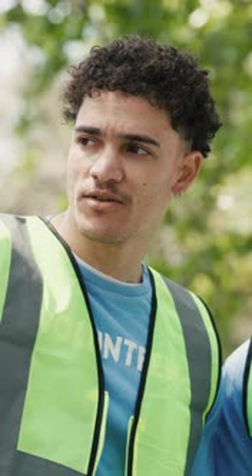 Park, volunteer and man talking with team for community service, non profit or coordination