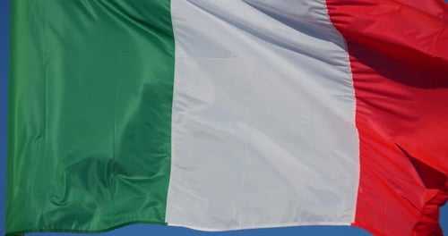 Italian Flag Waving Against Blue Sky