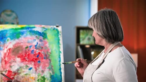 Senior Couple Painting Abstract Art Together Indoors