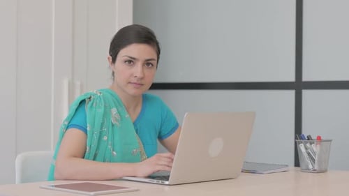 Woman Working at Laptop in Modern Office