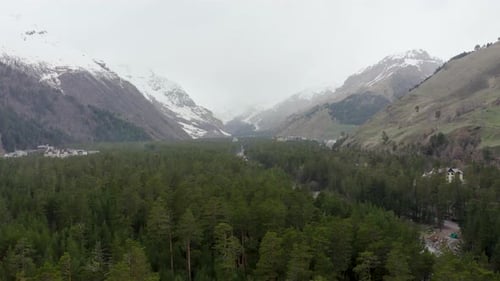 Caucasus Mountains and Green Valley Below