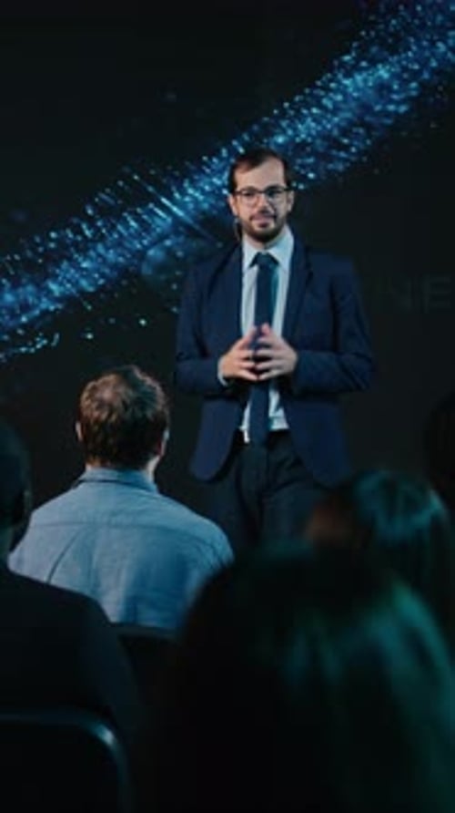 Businessman Giving Presentation to Audience in Conference Setting