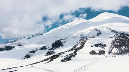 Stunning Aerial View of the Peaks of Elbrus Against the Blue Sky