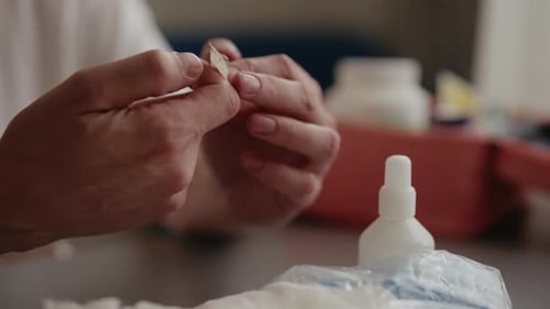Hands Applying Bandage on Finger Close Up