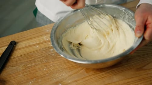 Mixing Dough in a Bowl with a Whisk