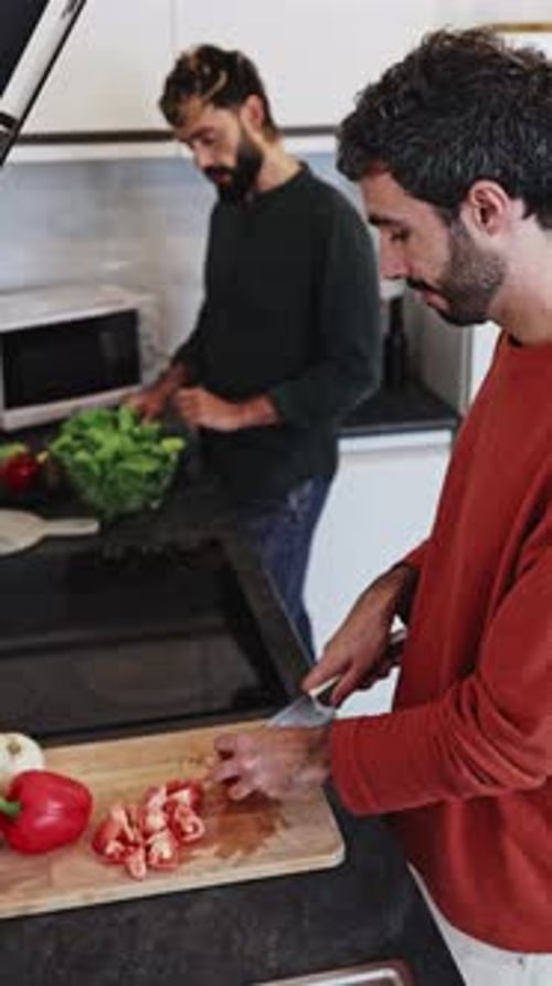 Two Men Preparing Food Together in Kitchen