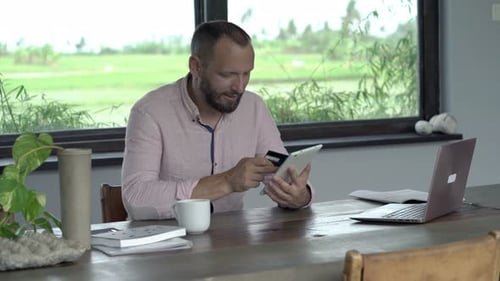 Man Shopping Online with Tablet and Credit Card