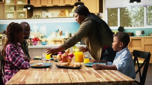 Family of Four Enjoying Breakfast Together at Home