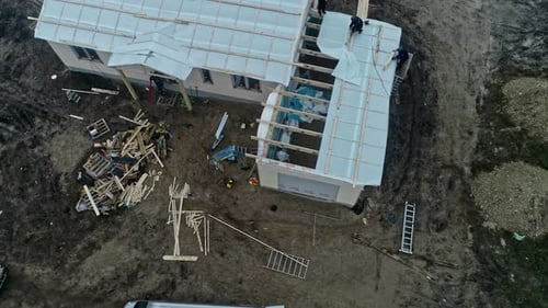 Unfinished Residential Building With Under Roof Plastic Sheet Insulation Installed. aerial pullback