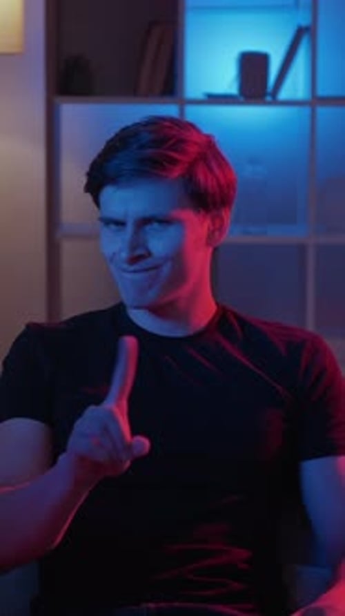 Young Adult Makes 'No No' Gesture Indoors