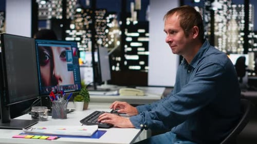 Man Editing Photo at Computer Workstation at Night