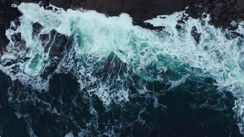 Waters of the Ocean Swirl Around the Rocky and Scenic Coastline Sea Waves Breaking Over Rocks