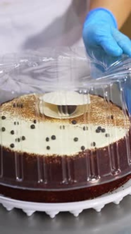 Chef Placing Lid on a Sweet Chocolate Cake