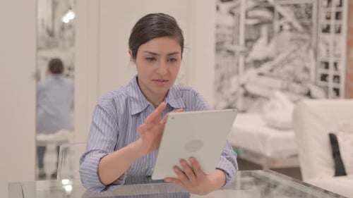 Woman Using Tablet Device in Bright Room