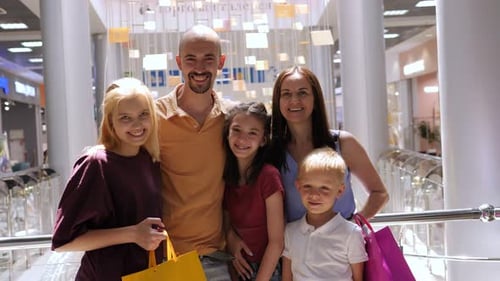 Portrait of a Big Happy Family in a Shopping Mall with Shopping Bags