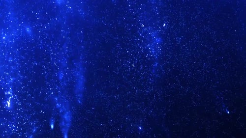 Fluid Motion of Glowing Blue Particles Abstract Background