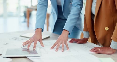 Architects Reviewing Plans in Modern Office