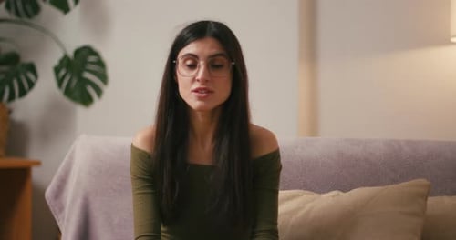 Smiling Woman Gives Thumbs Up at Home