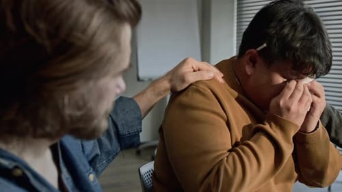 Diverse Men Crying, Supporting Each Other in Therapy Session