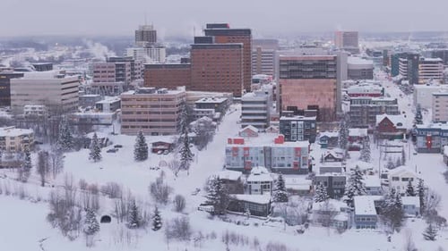 Drone shot of residential in Anchorage Alaska with cloudy snowy weather