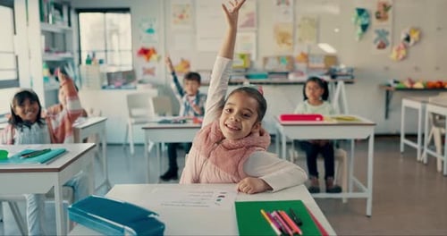 Students Raising Hands in Elementary School Classroom